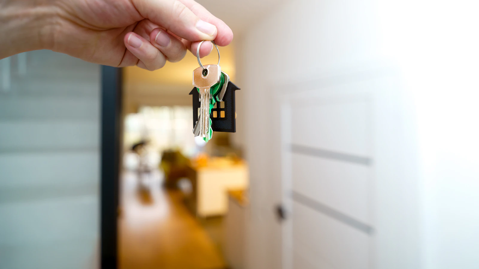 A hand holding the keys to a new home