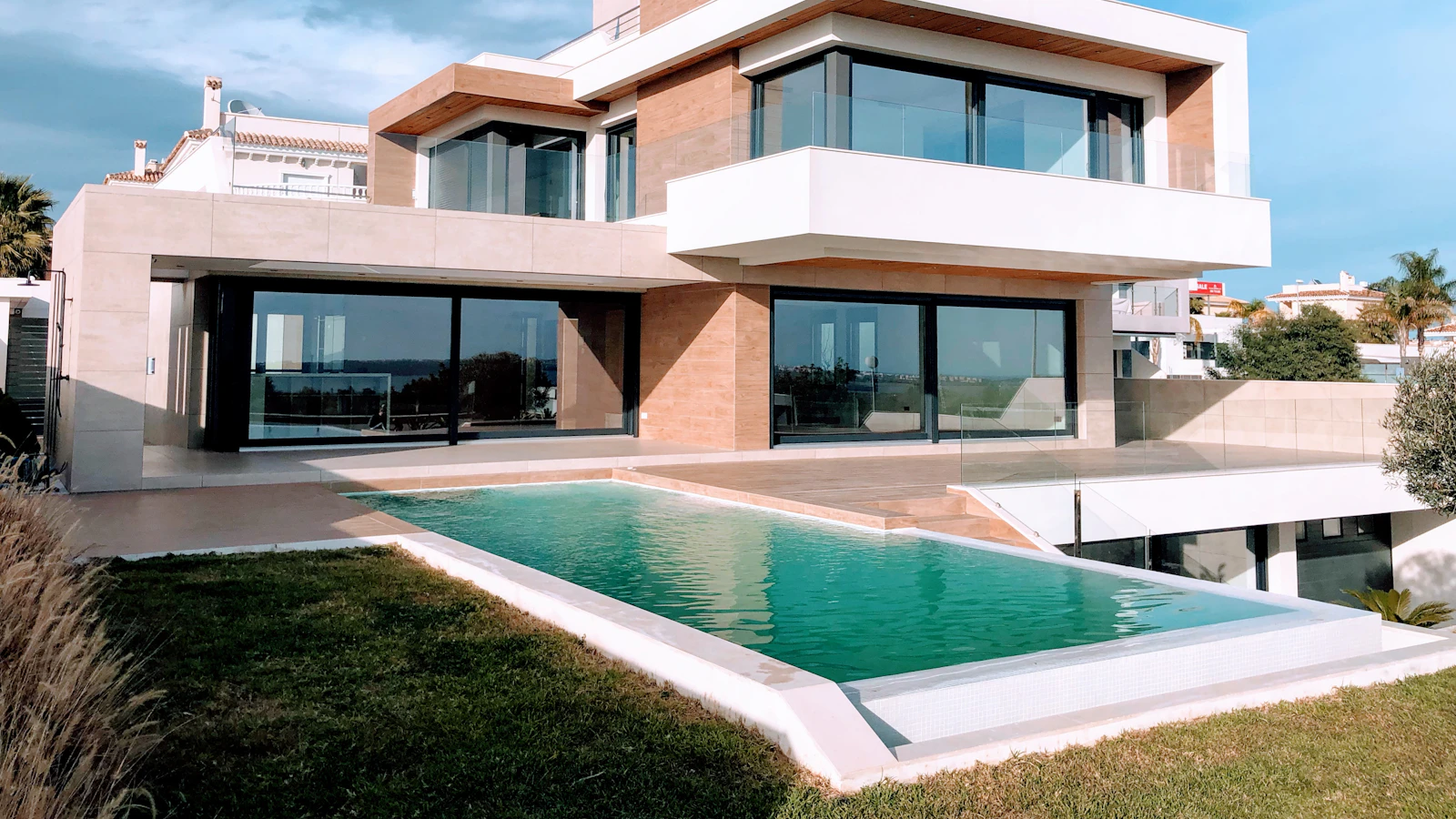 A modern white luxury house under a blue sky