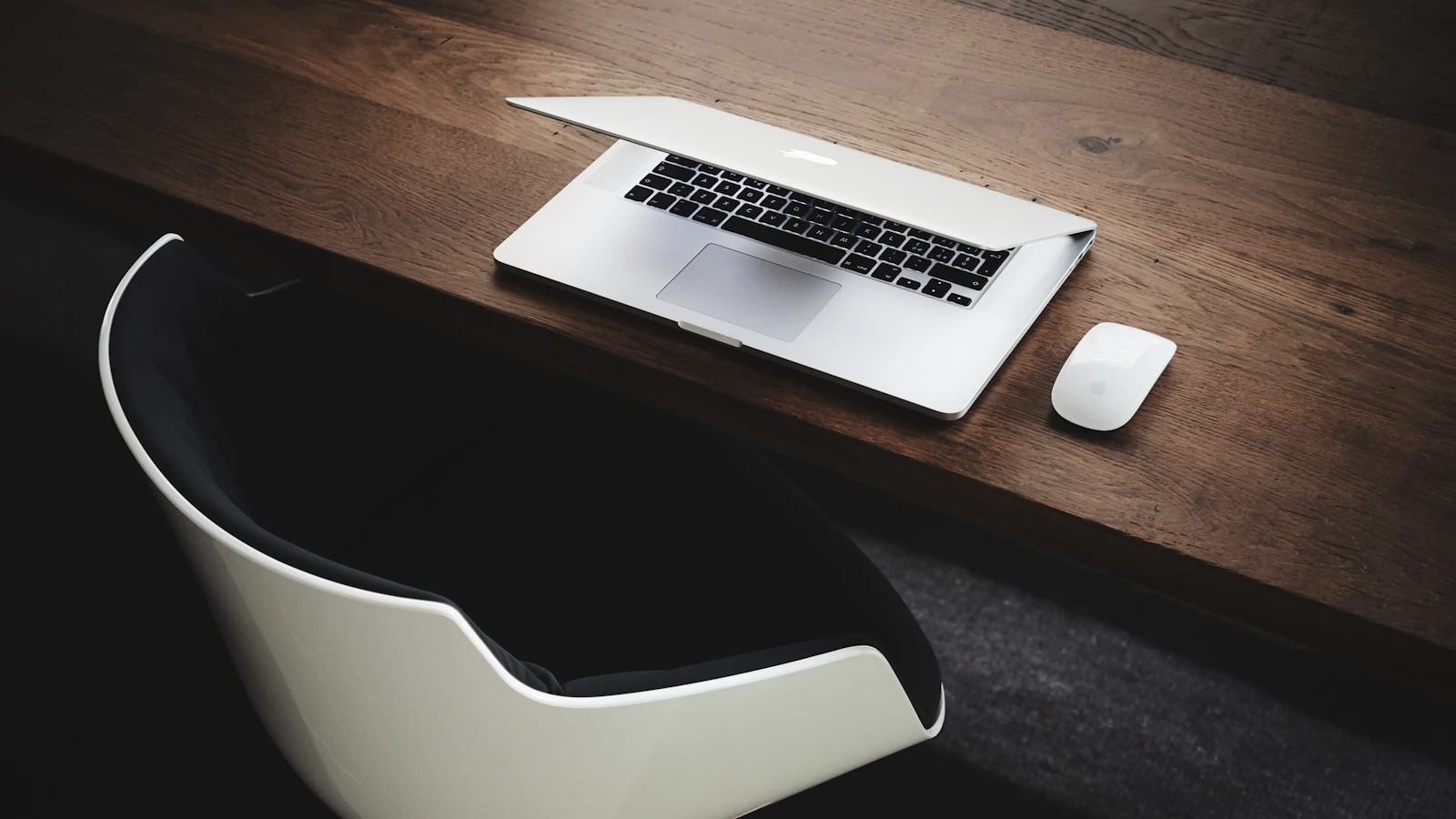 A desk with a computer and laptop set up for editing