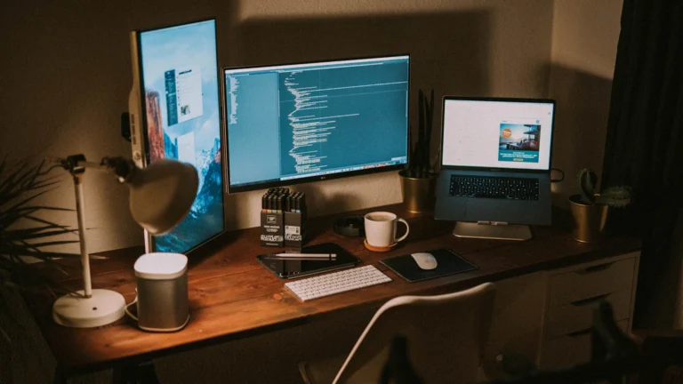 A home office desk with a laptop and an external monitor