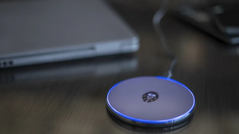 A smartphone charging on a wireless charger