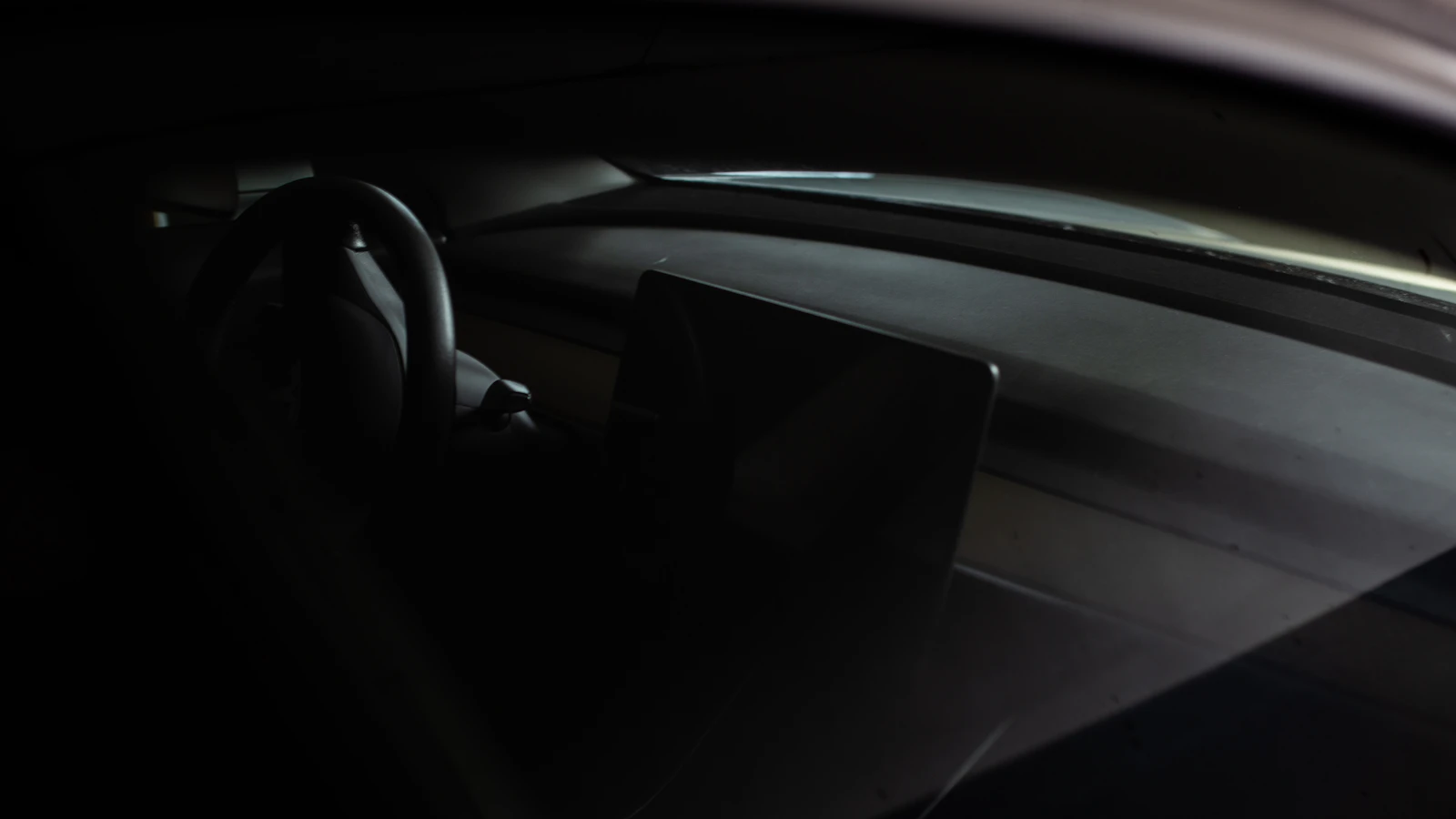 The interior of a modern car with a steering wheel and dashboard