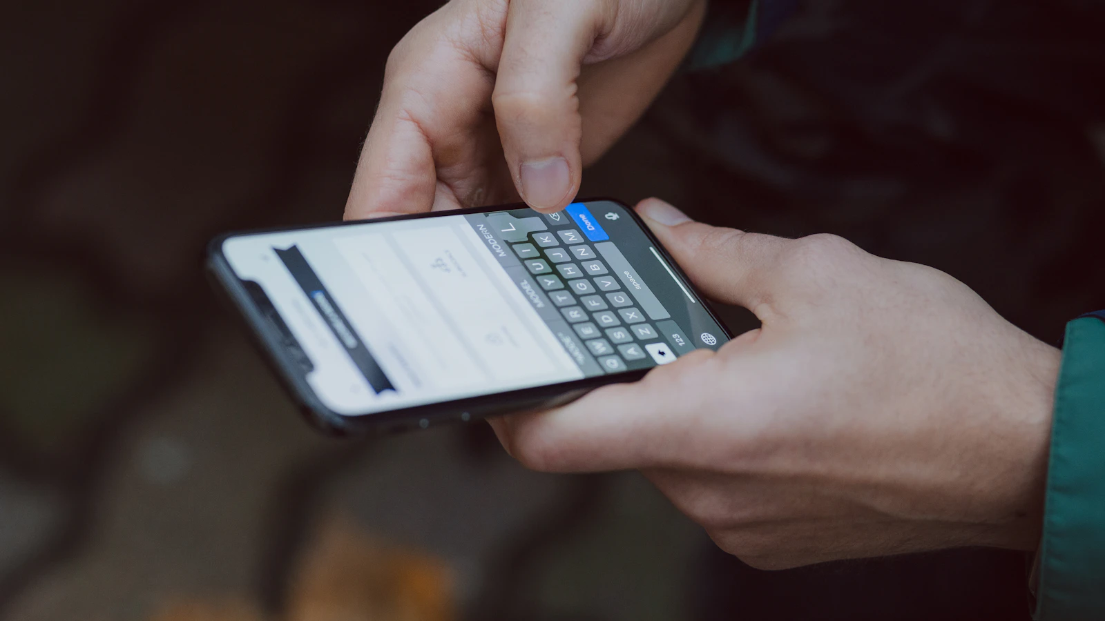 A person using a smartphone paired with wearable tech